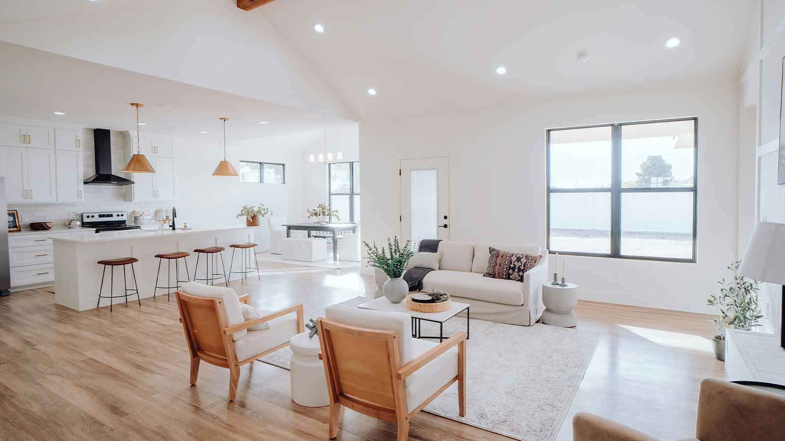 Bright open plan living room and kitchen in a newly built single family home with large windows