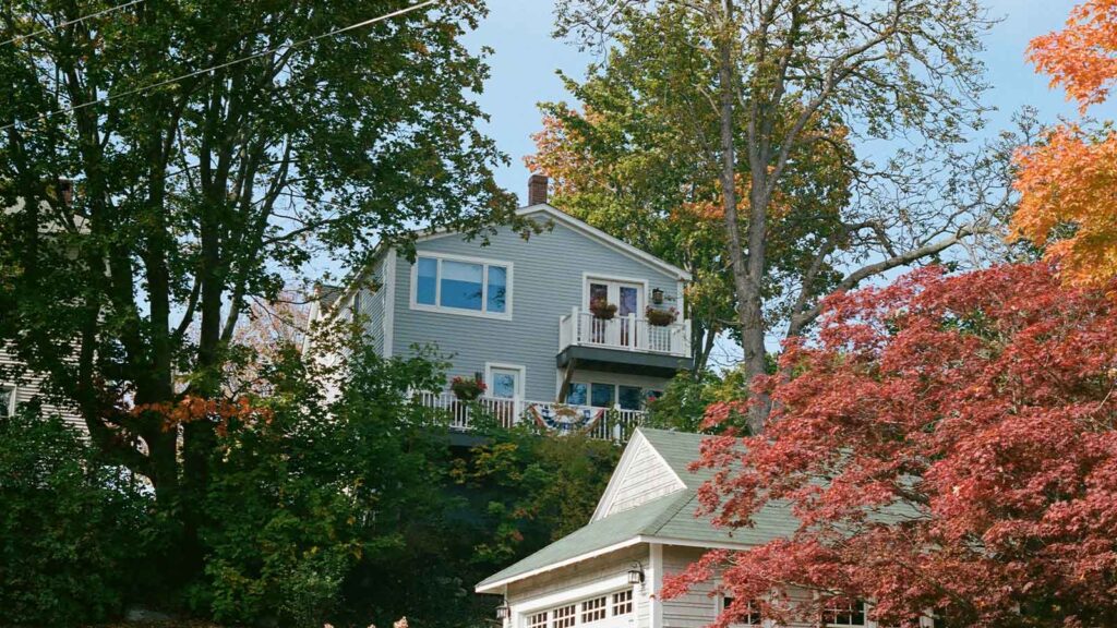a house with a balcony and trees an example of state of maine title search
