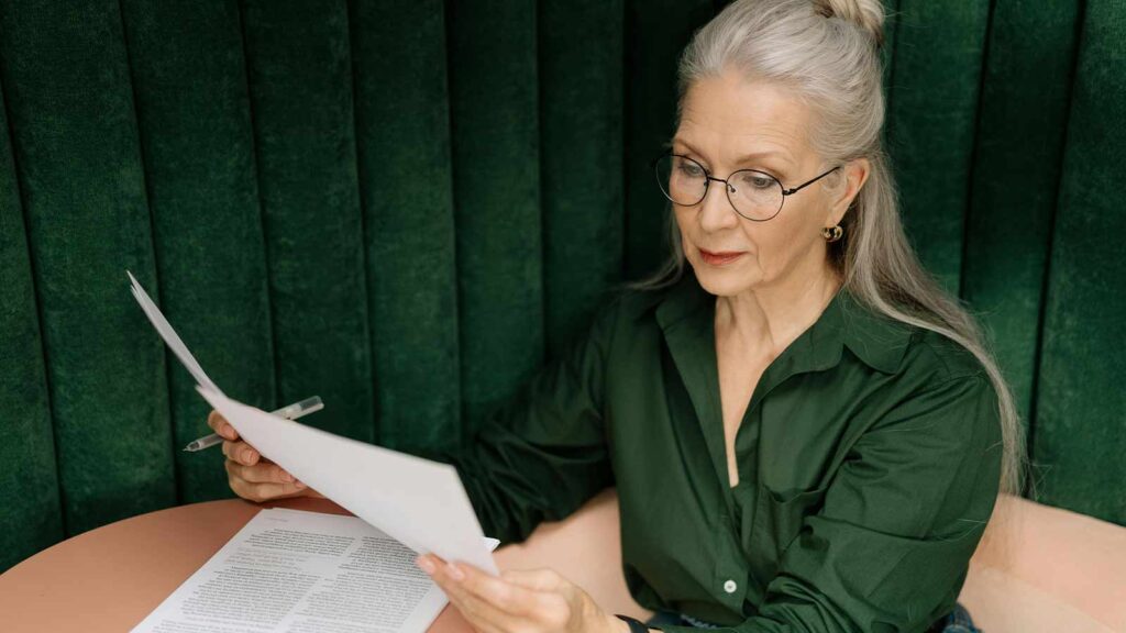 Image of a women reading over a abstract of title