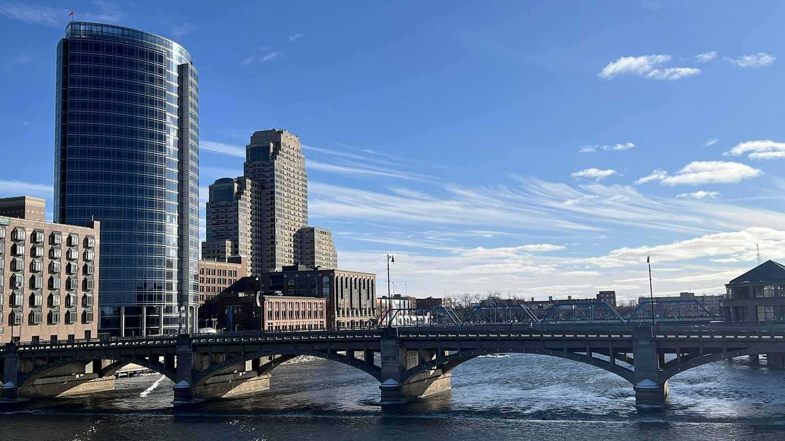 a bridge over a body of water with buildings in the background how to do a title search in Michigan
