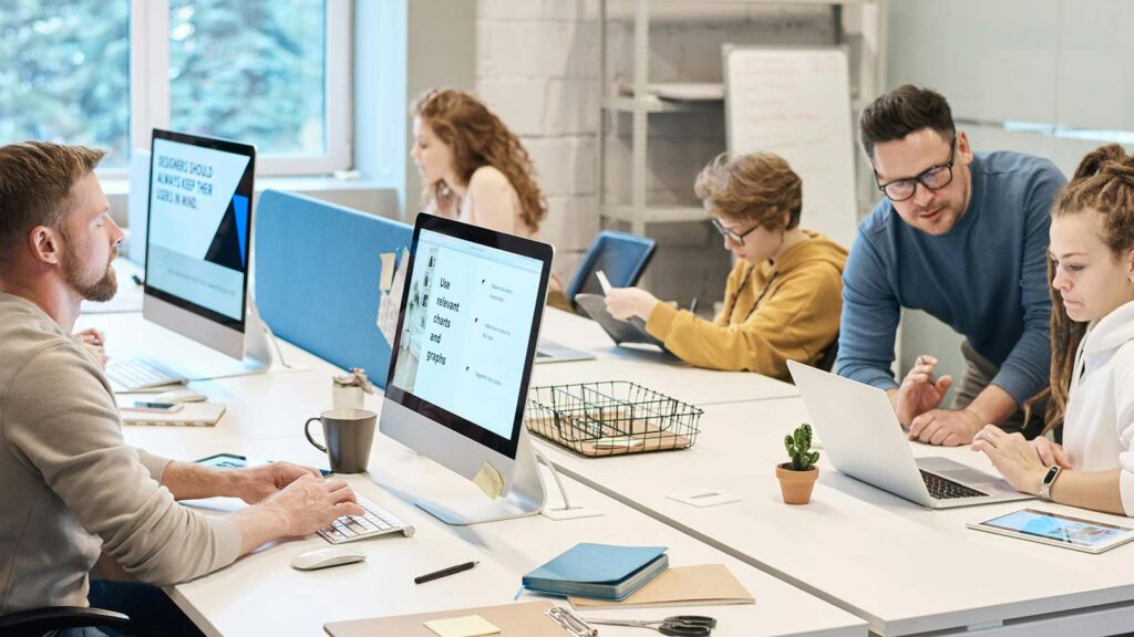 a group of people working on computers conducting a hawaii title search
