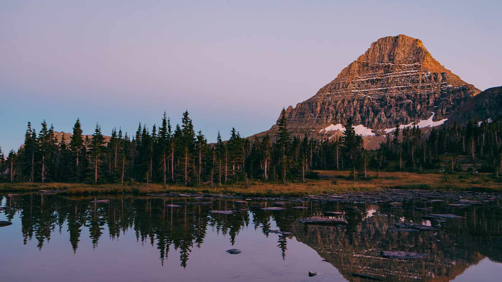 a mountain with trees and a lake title company title insurance title services best online title search company best title search company in montana title search companies that work nationwide