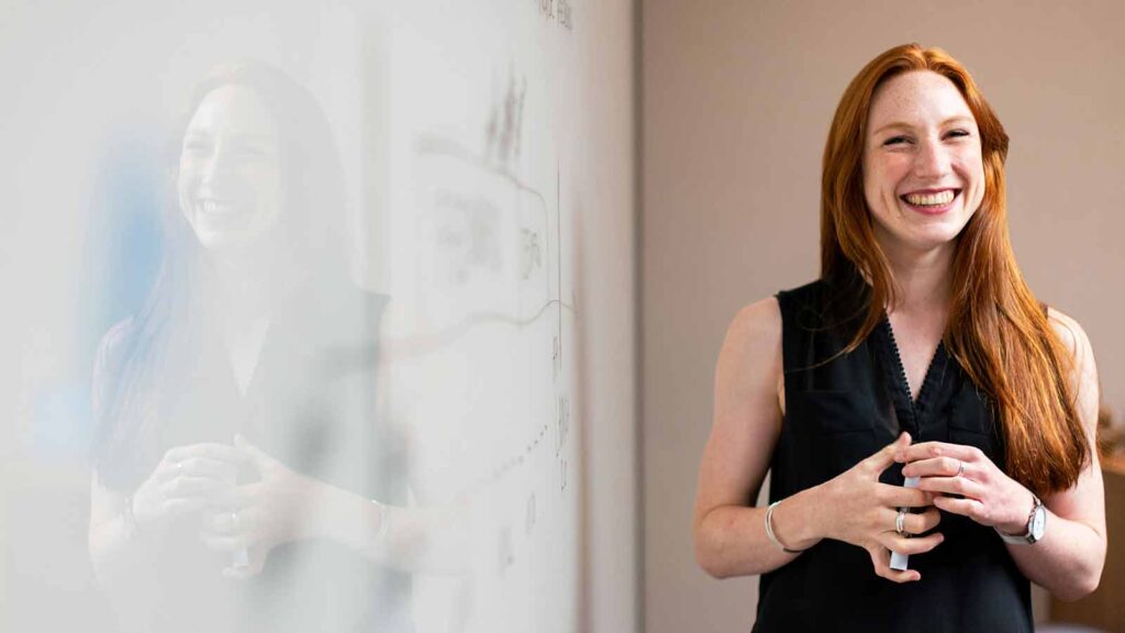 a woman standing in front of a whiteboard discussing Deed-Restricted Property