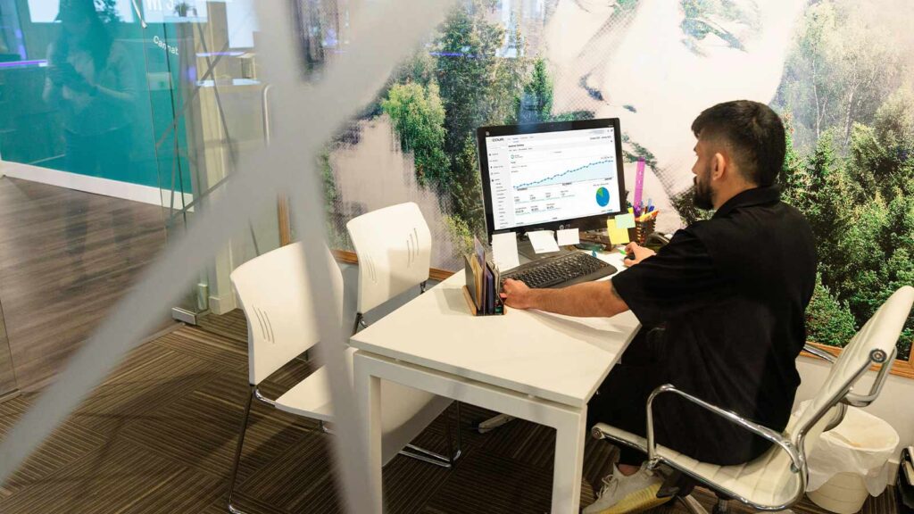 a man sitting at a desk using a computer Virginia Property Title Search