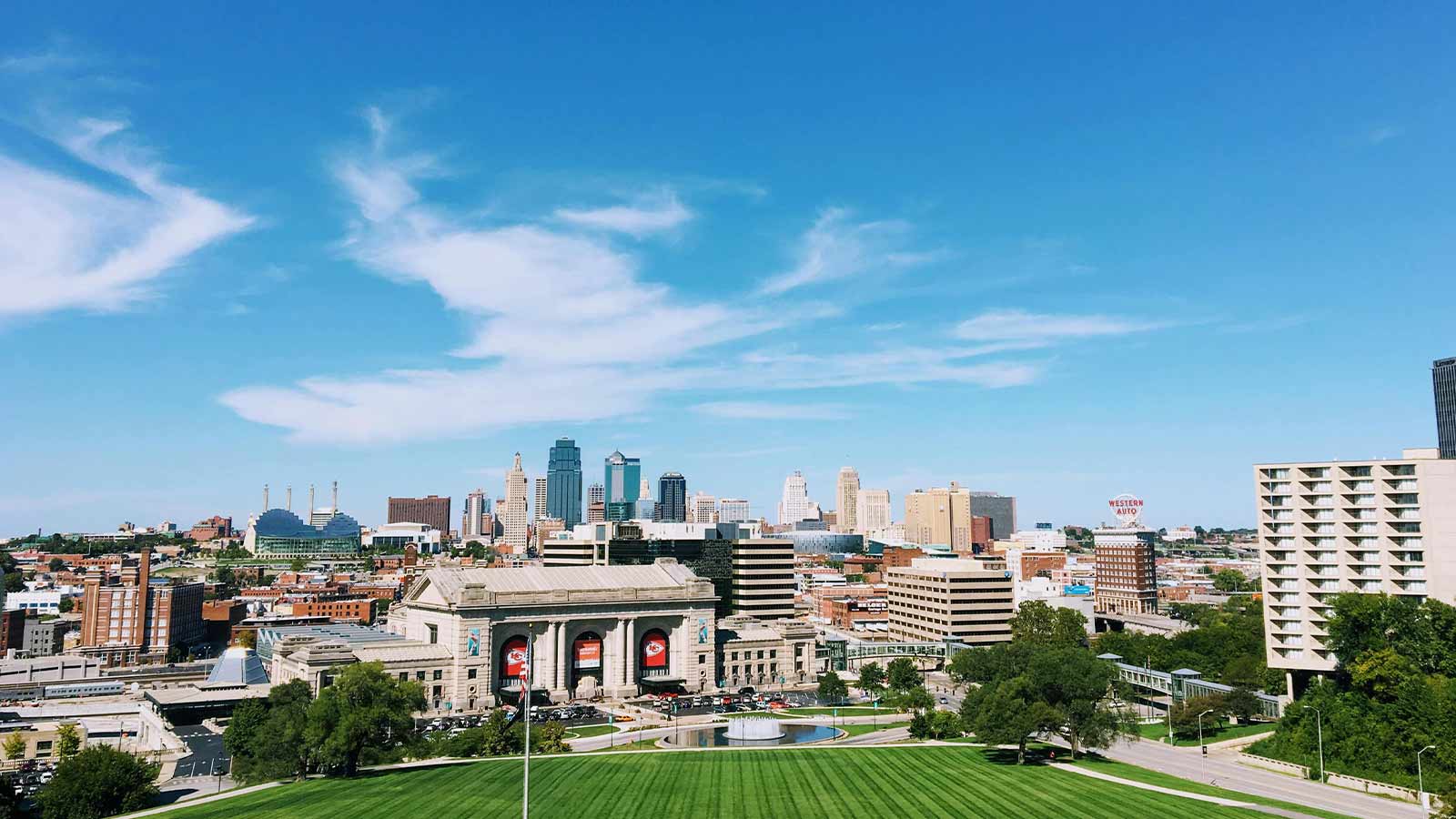 Kansas Title Search a city with a green lawn and a large building