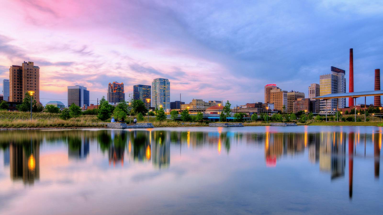 a city skyline with trees and a body of water Alabama Title Search Made Easy with AFX Research Experts