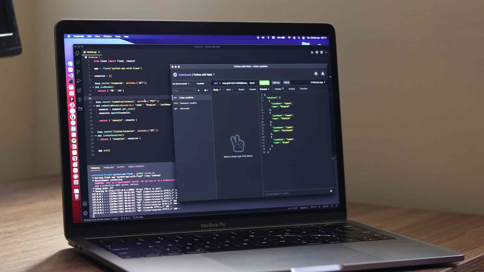 A laptop open on a desk with a development environment and a request tool on screen
