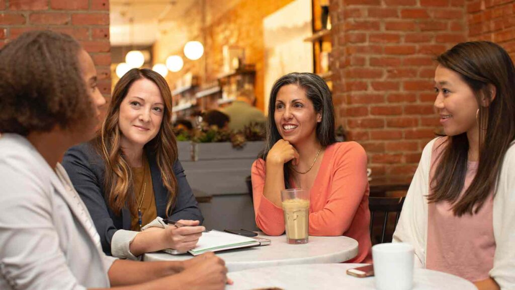 a group of women sitting at a table API integrations
