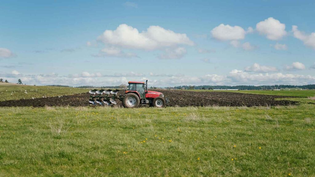 a tractor plowing a field Indiana Title Search