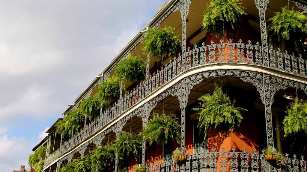 a building with plants on the balconies Louisiana Title Search