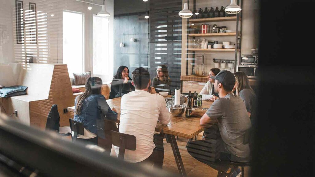 a group of people sitting around a table Nationwide Title Search Solutions for Every Industry: AFX Research Leads the Way