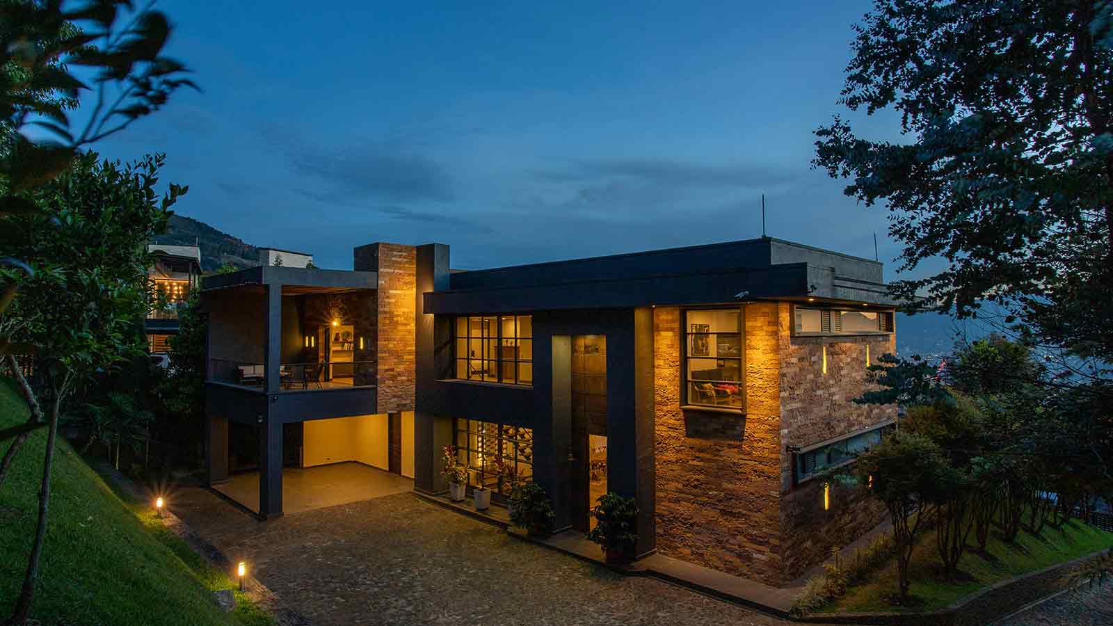 a building with a driveway and a tree AI title search
