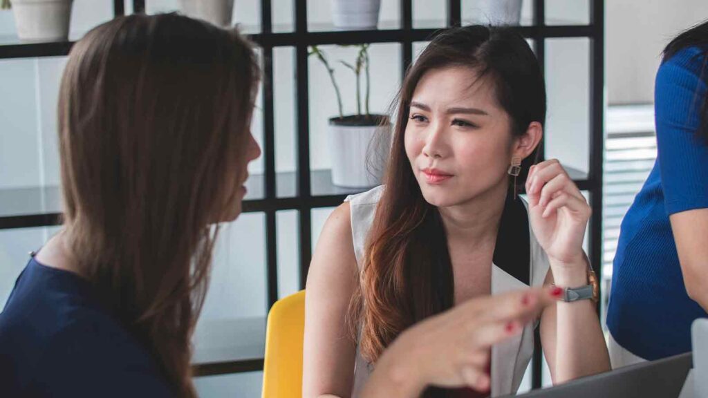 a woman talking to another woman AI title search