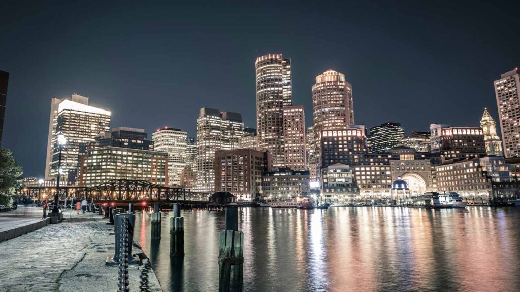 a city skyline with lights at night Property Searches