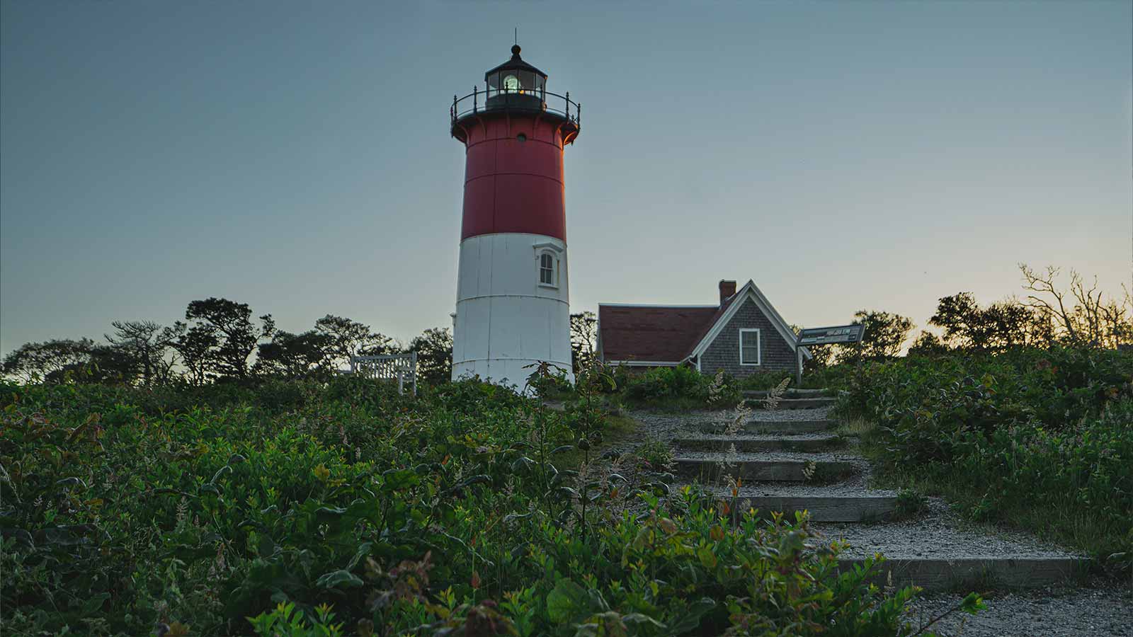a lighthouse with a house in the background Property Searches