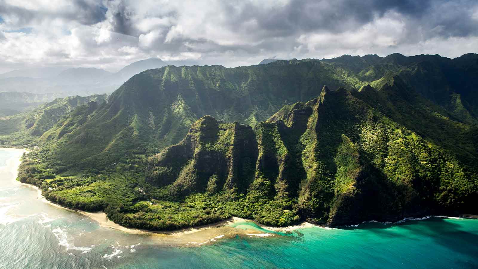 Lush green mountains meet turquoise ocean. AI Title Search in Hawaii