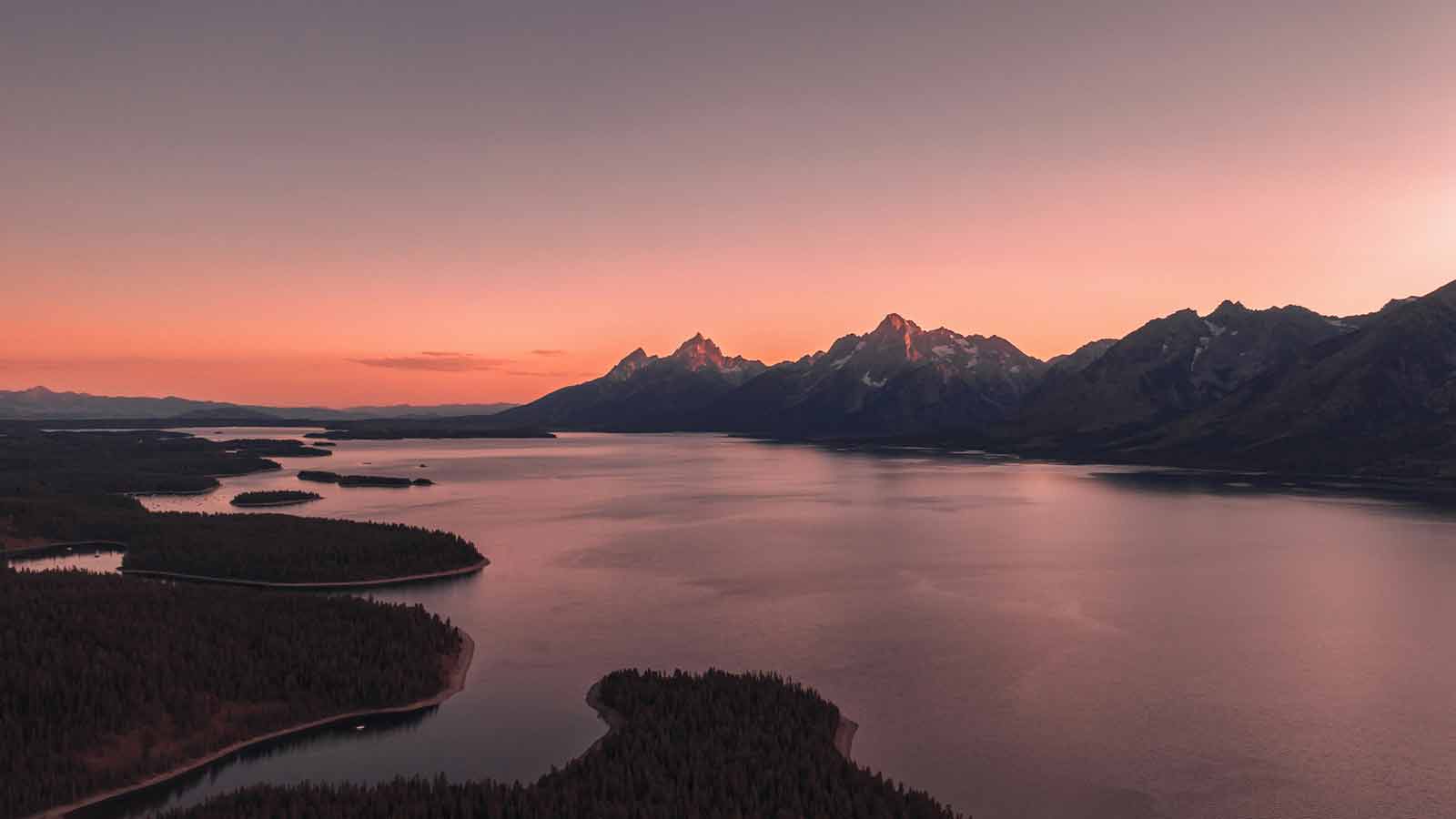 Serene lake with mountain sunset view AI title search in Wyoming
