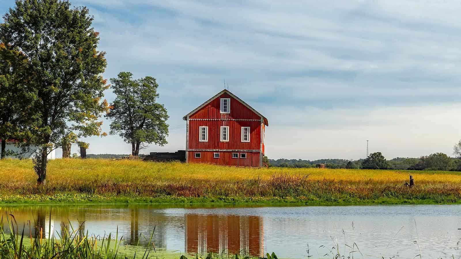 Red barn by tranquil water
